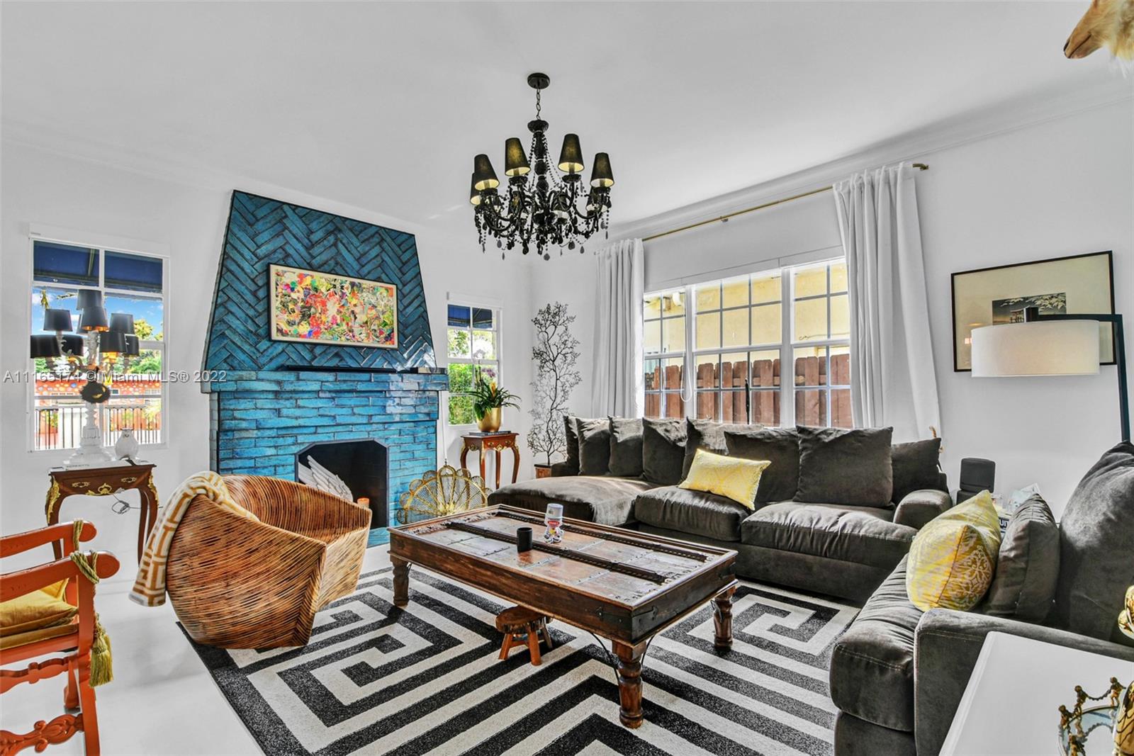 4722 Southwest 5th Street Miami, FL 33134 - Photo 11 of 36 a living room with furniture a flat screen tv and a fireplace
