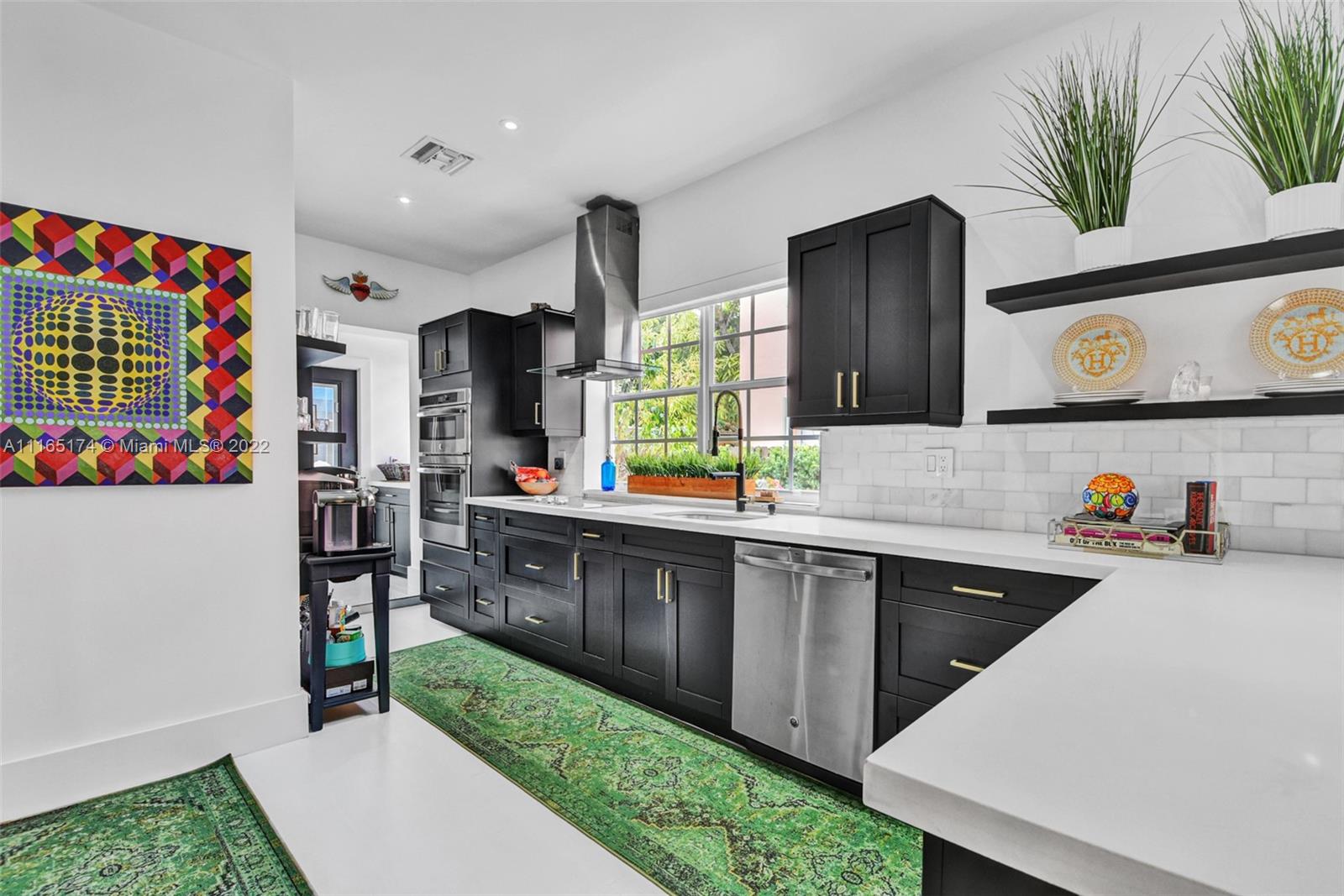 4722 Southwest 5th Street Miami, FL 33134 - Photo 13 of 36 a kitchen with lots of counter top space and wooden floor