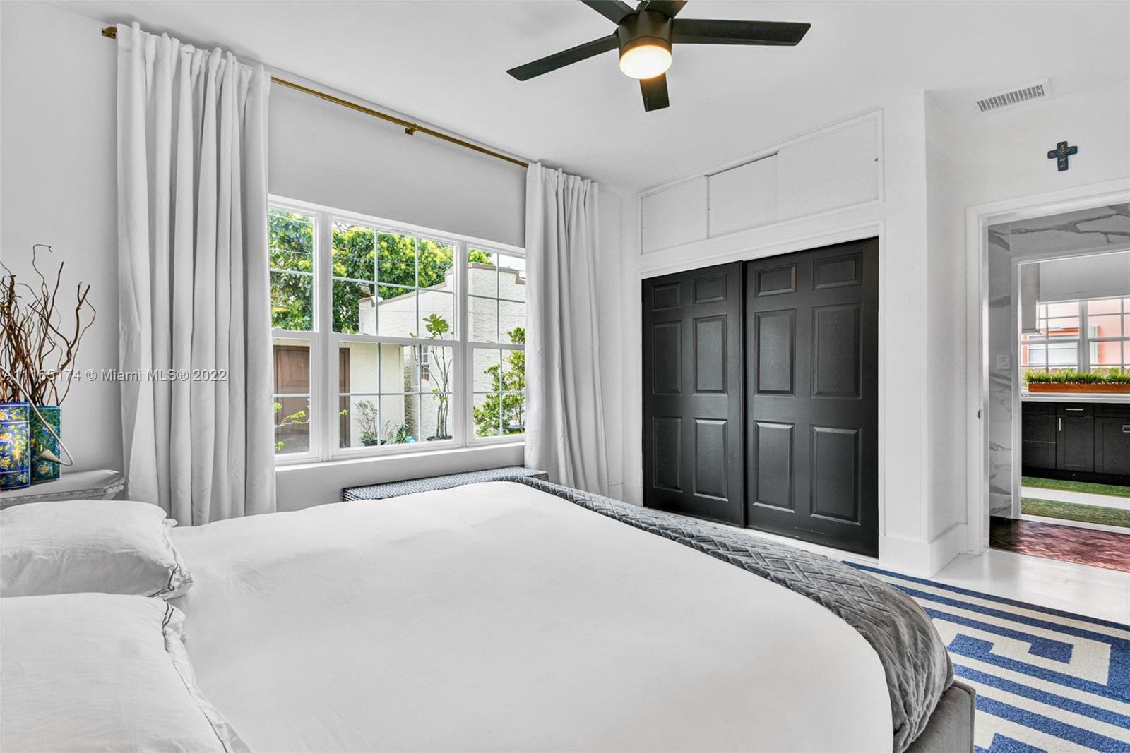 4722 Southwest 5th Street Miami, FL 33134 - Photo 19 of 36 a bedroom with a bed and a large window with a flat tv screen