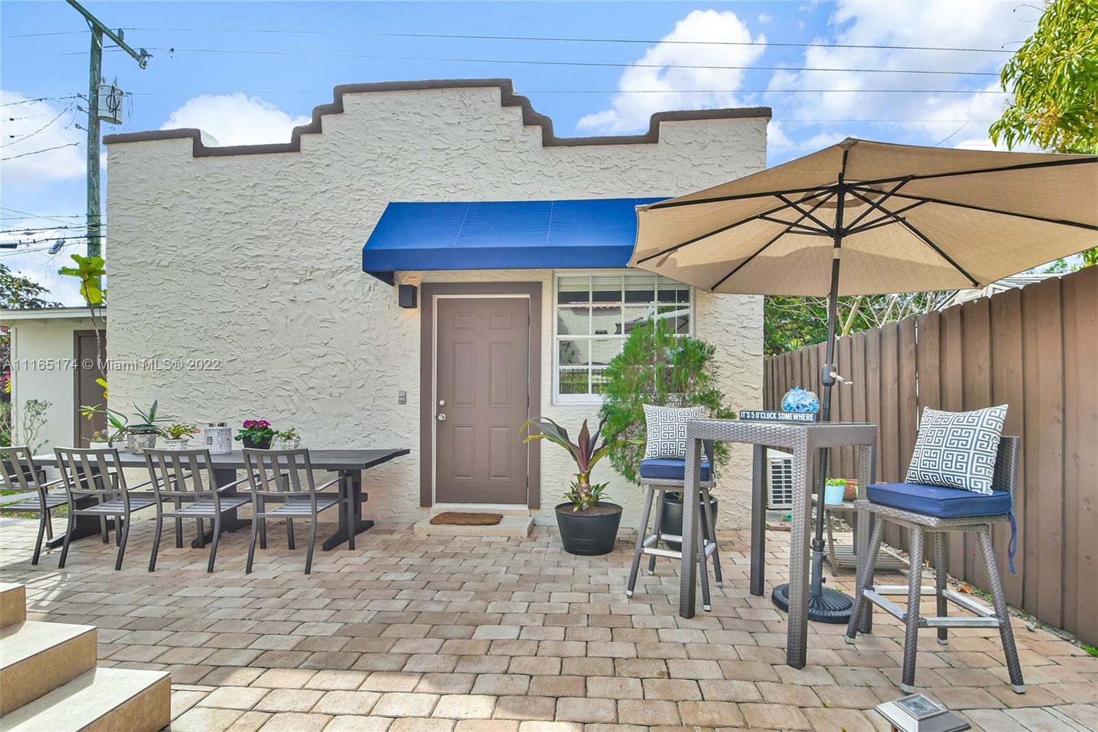 4722 Southwest 5th Street Miami, FL 33134 - Photo 27 of 36 a patio with a patio table and chairs