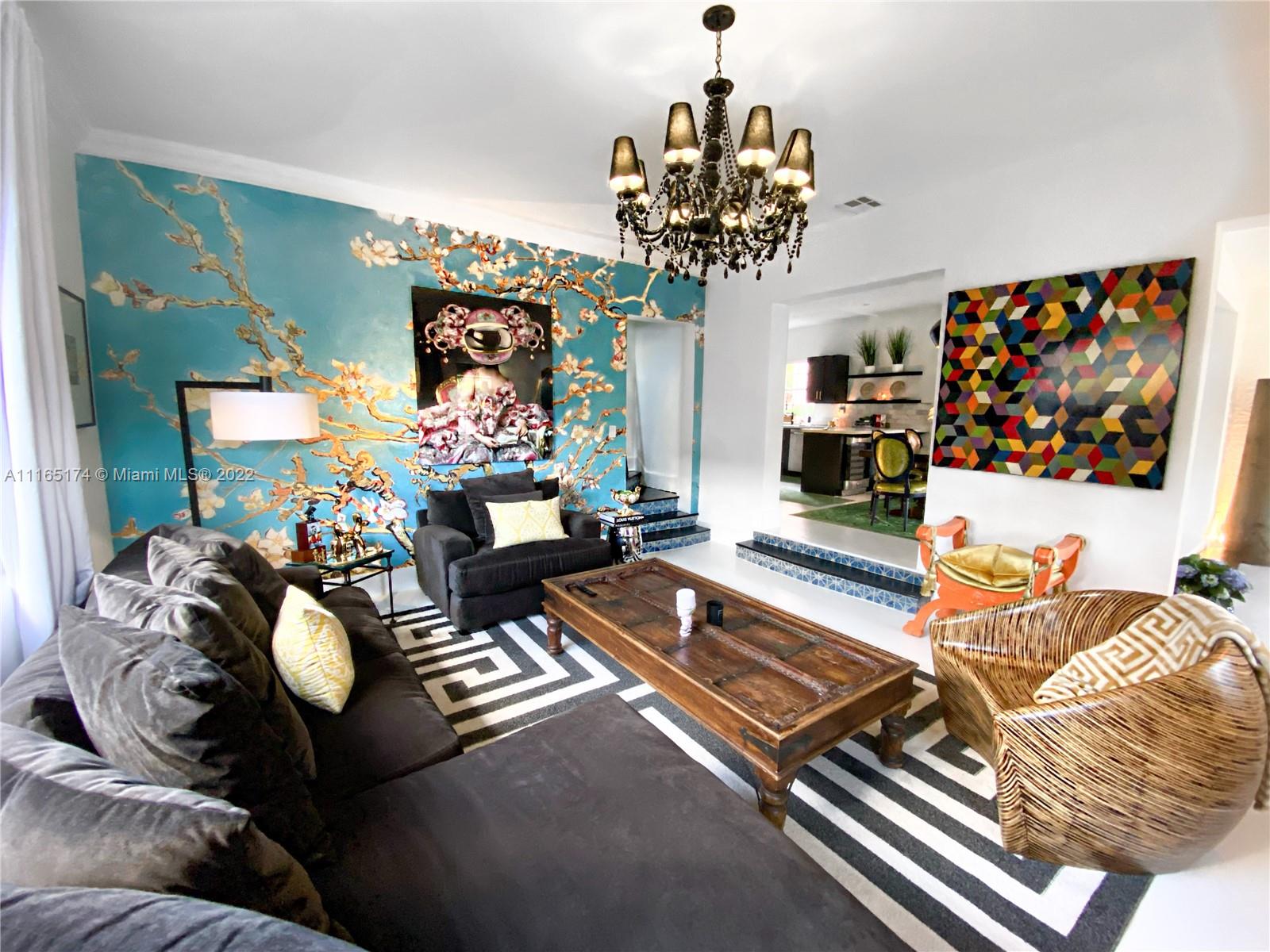 4722 Southwest 5th Street Miami, FL 33134 - Photo 9 of 36 a living room with furniture flowers and a chandelier