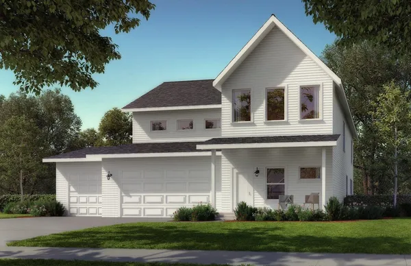 a front view of a house with a garden and plants