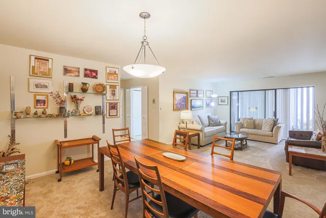 a living room with furniture a window and a chandelier