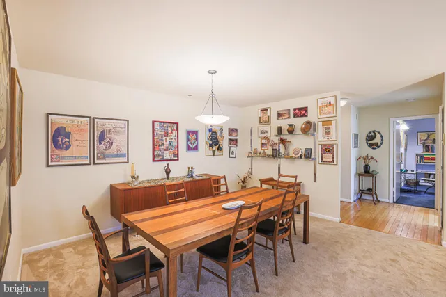a dining room with furniture and wooden floor