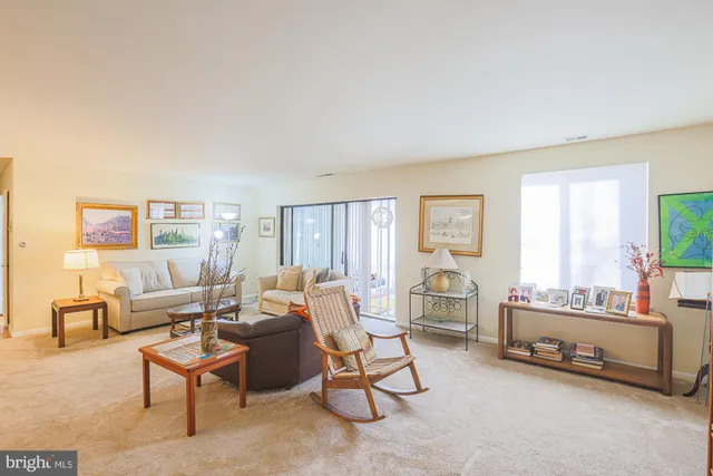 a living room with furniture and a lamp