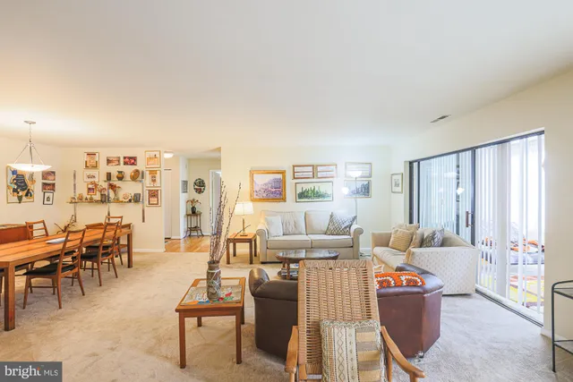 a living room with furniture and a bookshelf