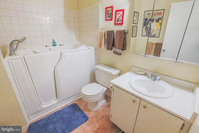 a white toilet sitting next to a bathroom sink