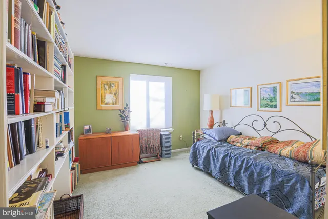 a bedroom with furniture and a book shelf
