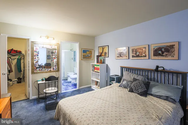 a bedroom with bed and wooden floor