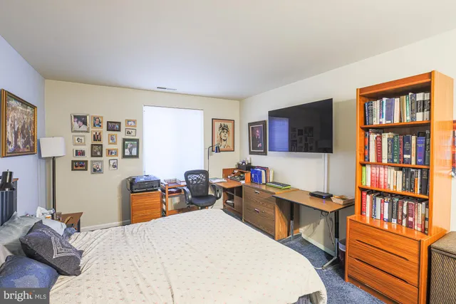 a bed room with a bed window and a chair in it