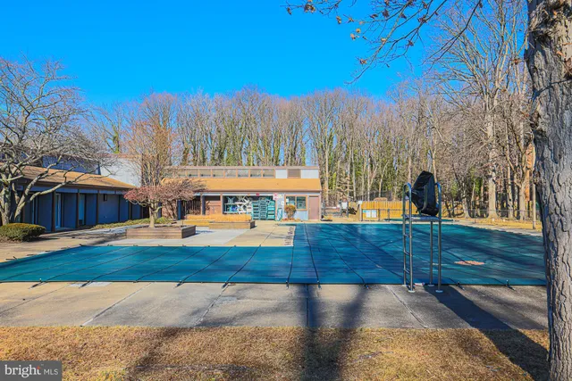 a view of a swimming pool with an outdoor space and seating area