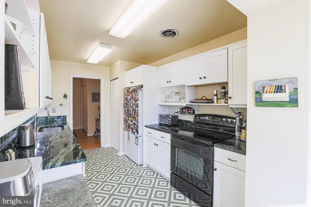 a kitchen with a stove and a cabinets