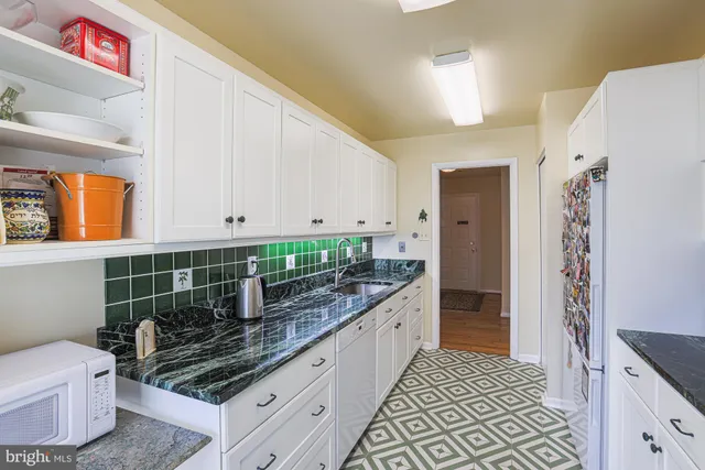 a kitchen with stainless steel appliances kitchen island granite countertop a refrigerator and a stove
