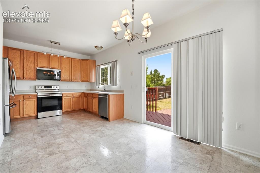 7904 Coffee Road Peyton, CO 80831 - Photo 8 of 48 Light-filled dining area with direct access to a private wood deck
