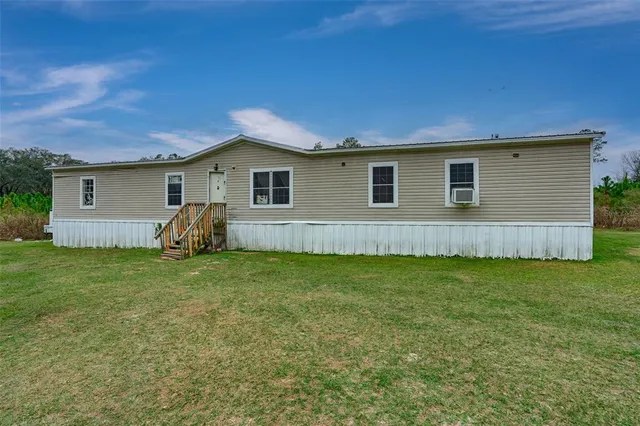 a view of a house with a backyard