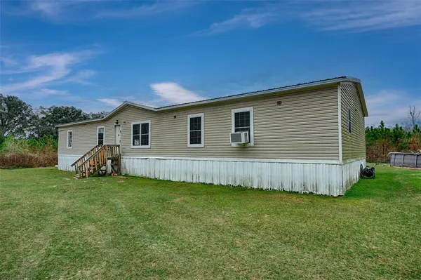 a view of a house with a backyard