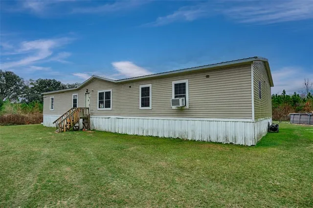 a view of a house with a backyard