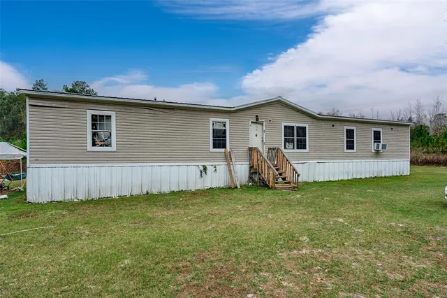 a backyard of a house with lots of green space
