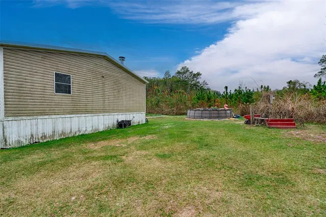 a wooden fence with some trees in the background