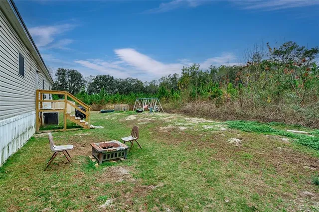 a view of a house with yard and a garden