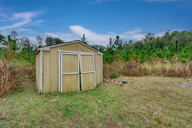 a aerial view of a house with a yard and lake view