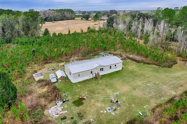 a view of a lush green outdoor space with a lake view