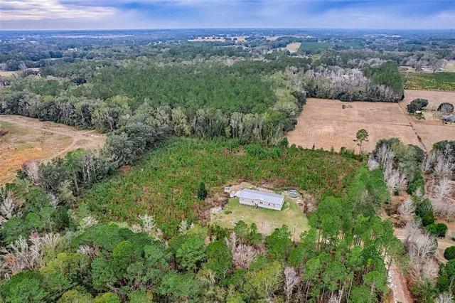 an aerial view of a house with a yard