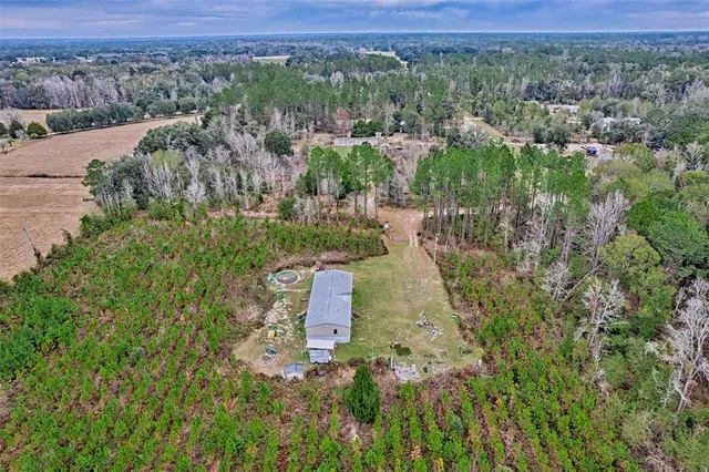 an aerial view of a house with a yard