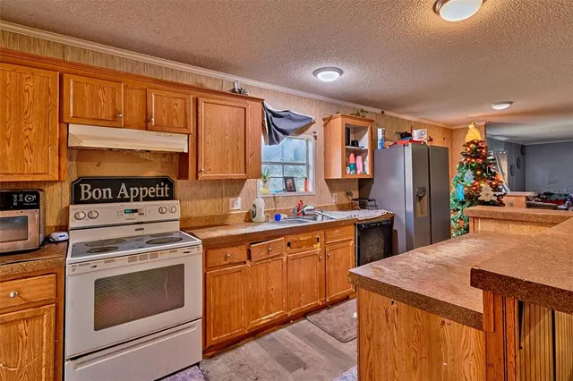 a kitchen with a stove top oven sink and cabinets