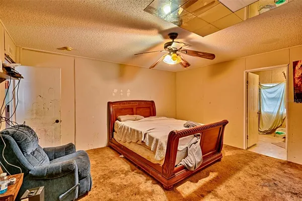 a bedroom with a bed a couch and dresser