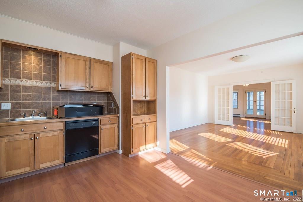 2 Pleasant Street, Unit 2 Windsor Locks, CT 06096 - Photo 7 of 11 a kitchen with stainless steel appliances granite countertop a stove a sink and a refrigerator