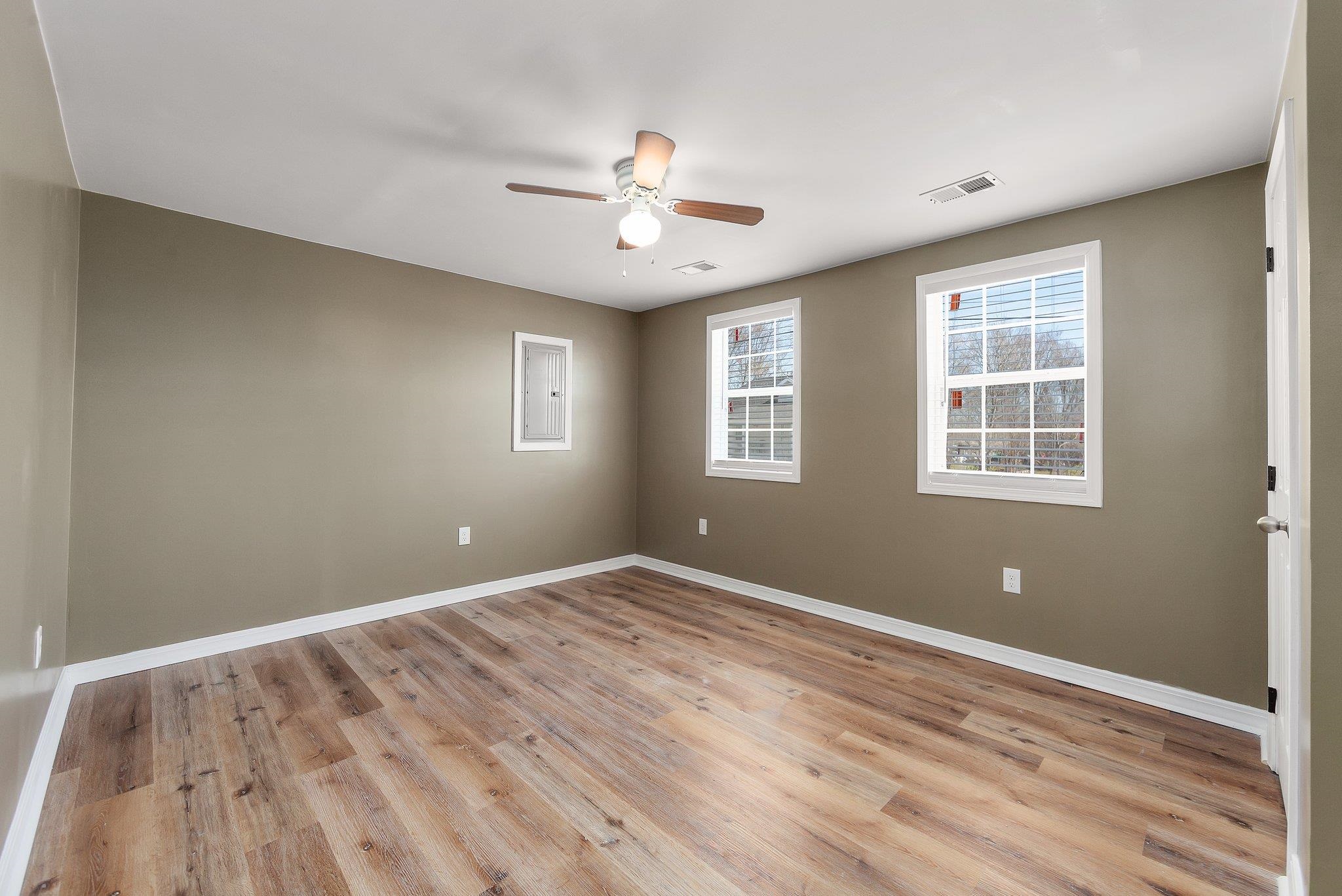 115 Carson Street Jackson, TN 38301 - Photo 6 of 14 a view of an empty room with wooden floor and a window