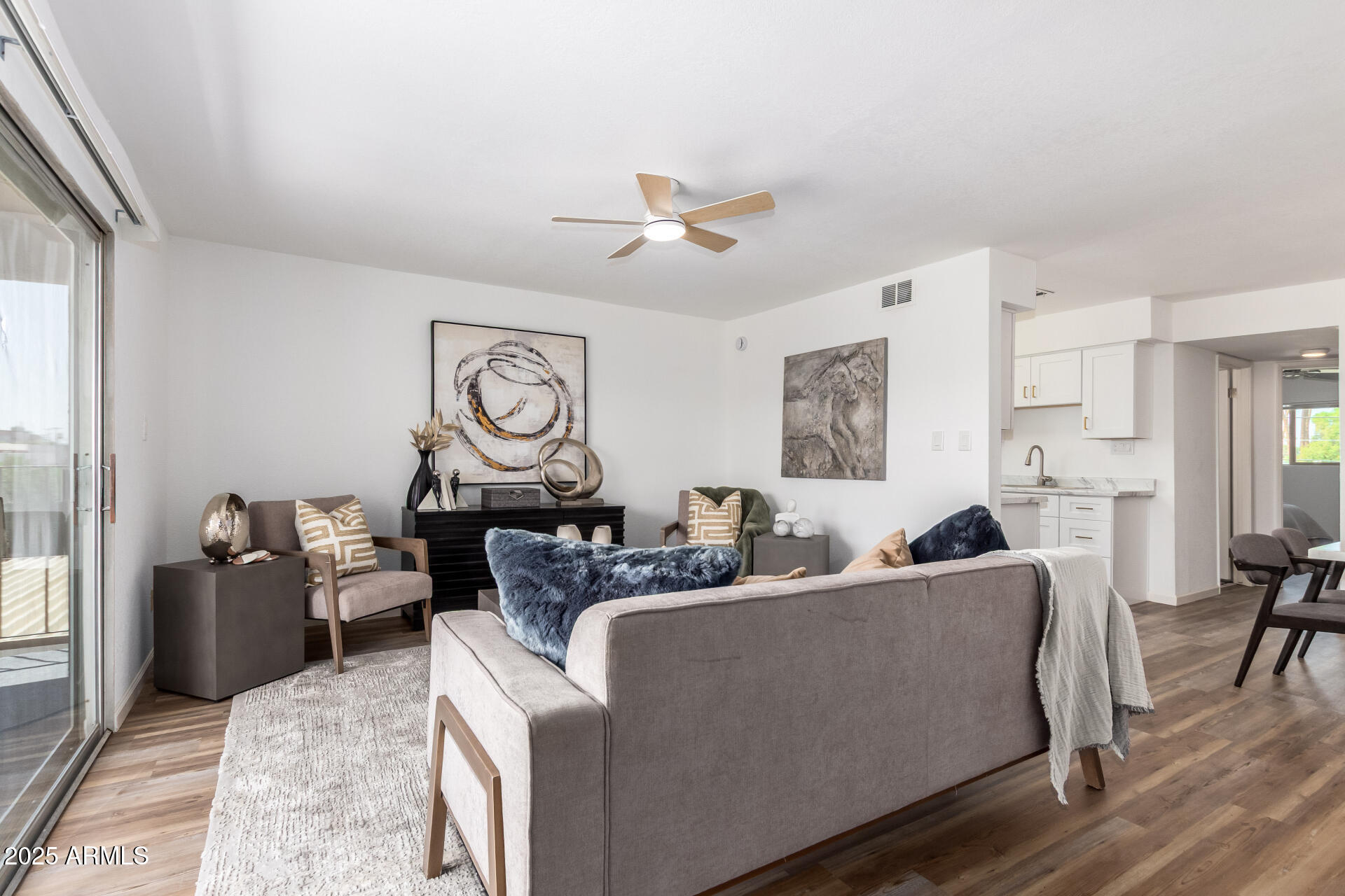 a living room with furniture a fireplace and a window