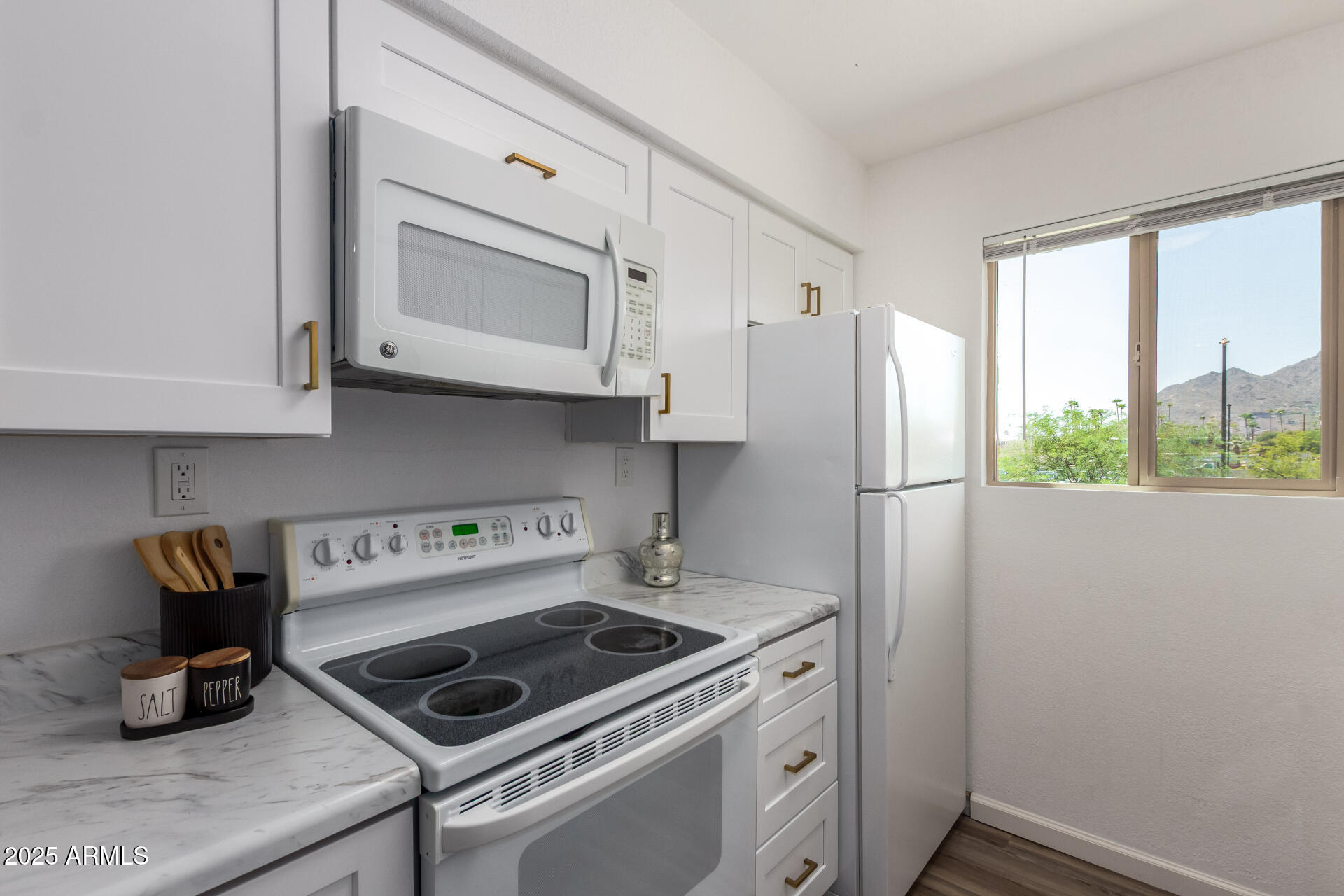 7430 East Chaparral Road, Unit 245A Scottsdale, AZ 85250 - Photo 11 of 30 a kitchen with a stove and a refrigerator
