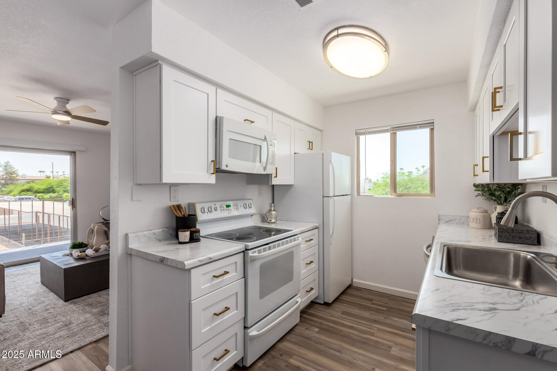 7430 East Chaparral Road, Unit 245A Scottsdale, AZ 85250 - Photo 12 of 30 a kitchen with stainless steel appliances granite countertop a sink stove and cabinets