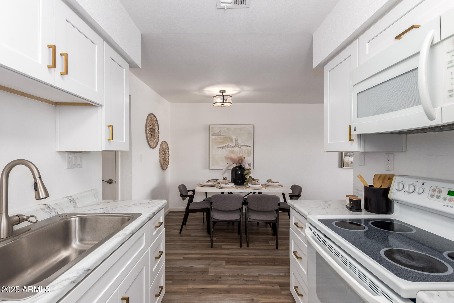 7430 East Chaparral Road, Unit 245A Scottsdale, AZ 85250 - Photo 13 of 30 a kitchen with a stove and a white wooden cabinets