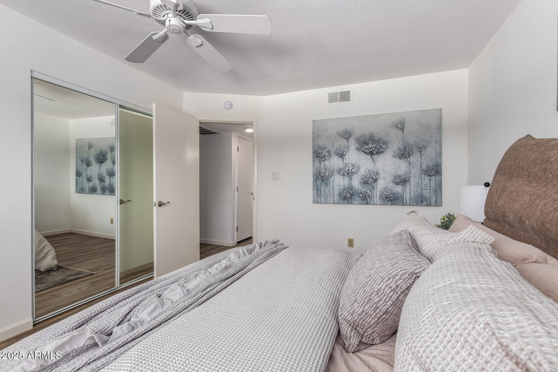 7430 East Chaparral Road, Unit 245A Scottsdale, AZ 85250 - Photo 16 of 30 a bedroom with a large bed and a chandelier