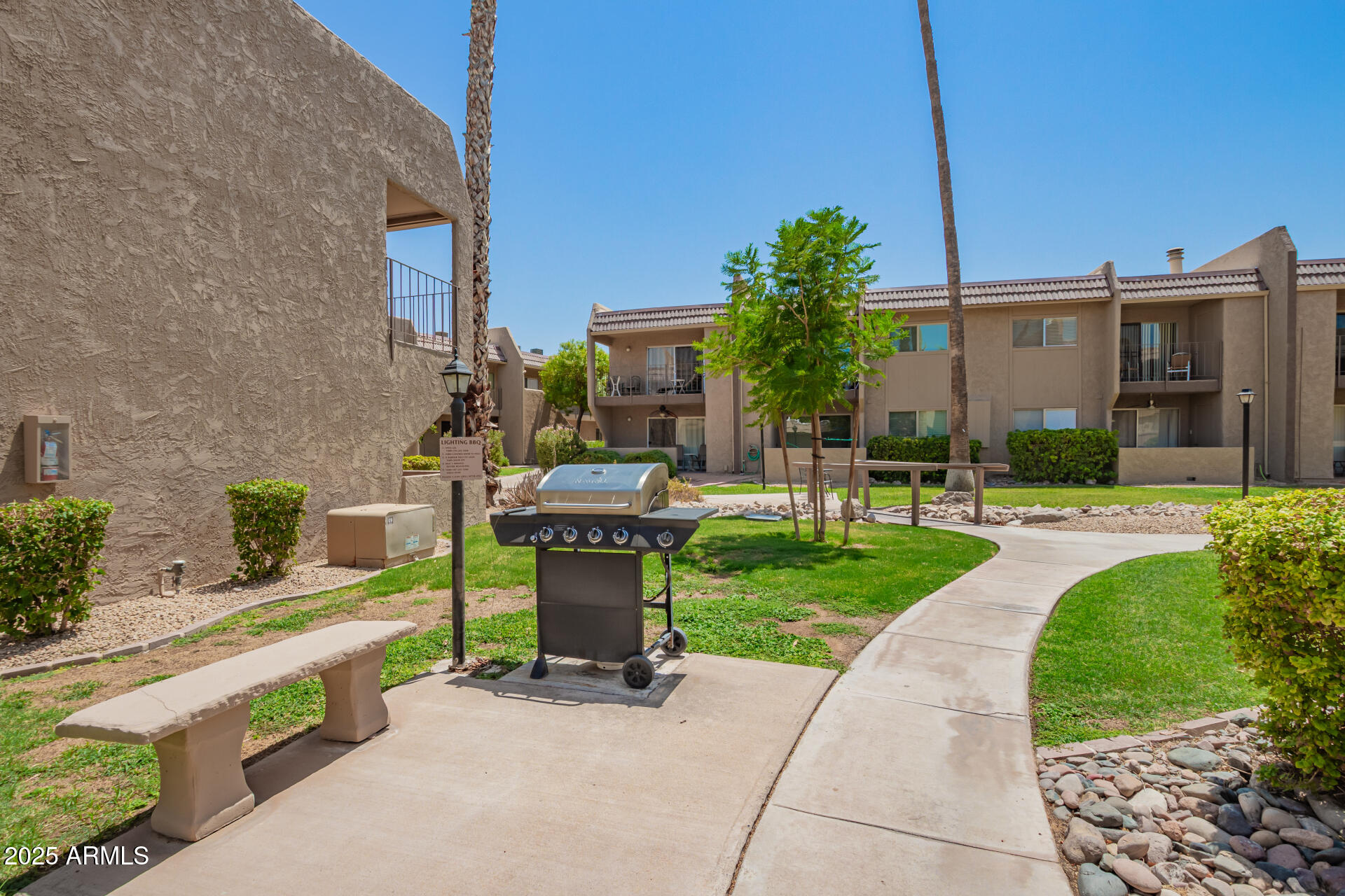 7430 East Chaparral Road, Unit 245A Scottsdale, AZ 85250 - Photo 27 of 30 a view of a patio with table and chairs and potted plants