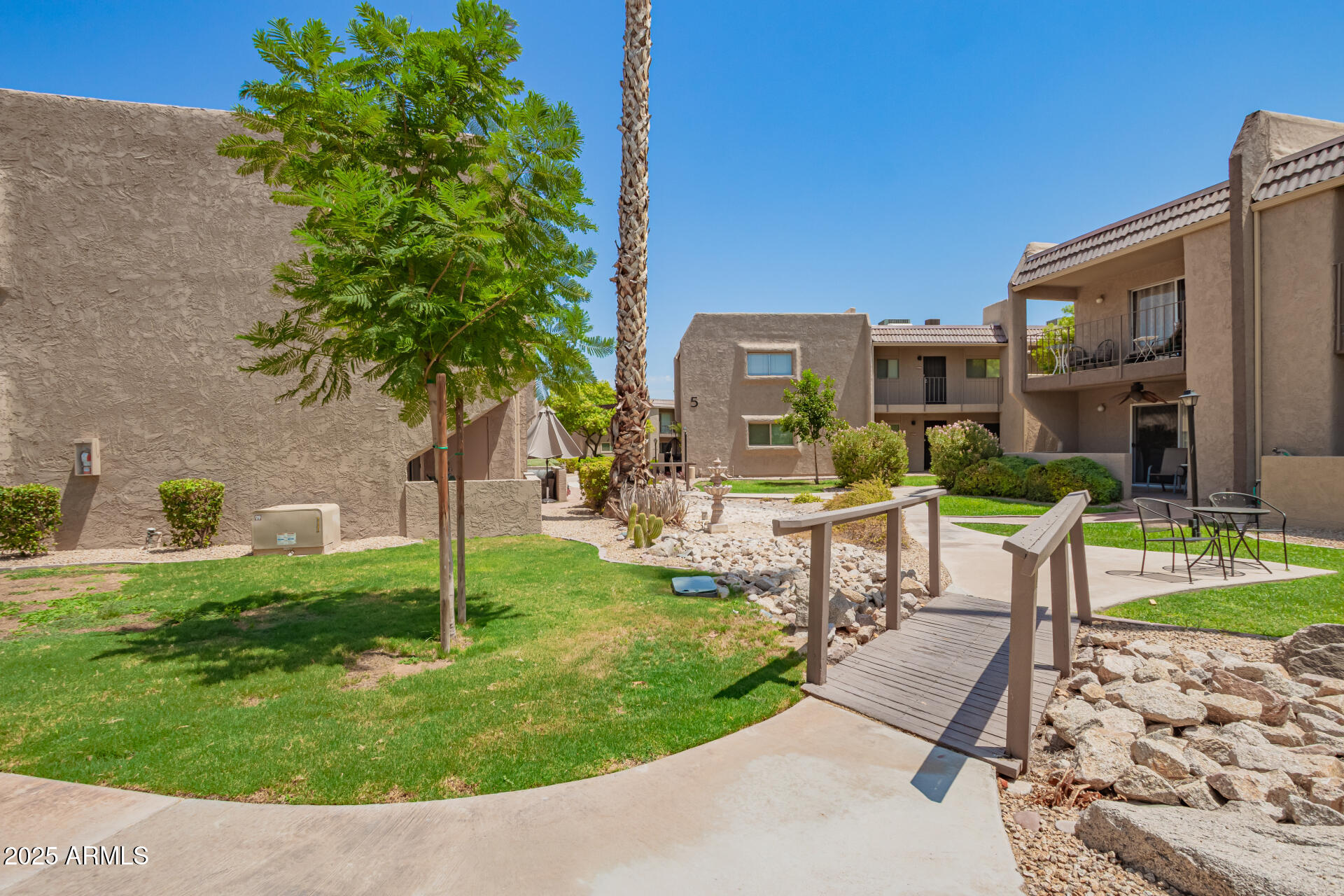 7430 East Chaparral Road, Unit 245A Scottsdale, AZ 85250 - Photo 28 of 30 a view of a patio with couches table and chairs and potted plants