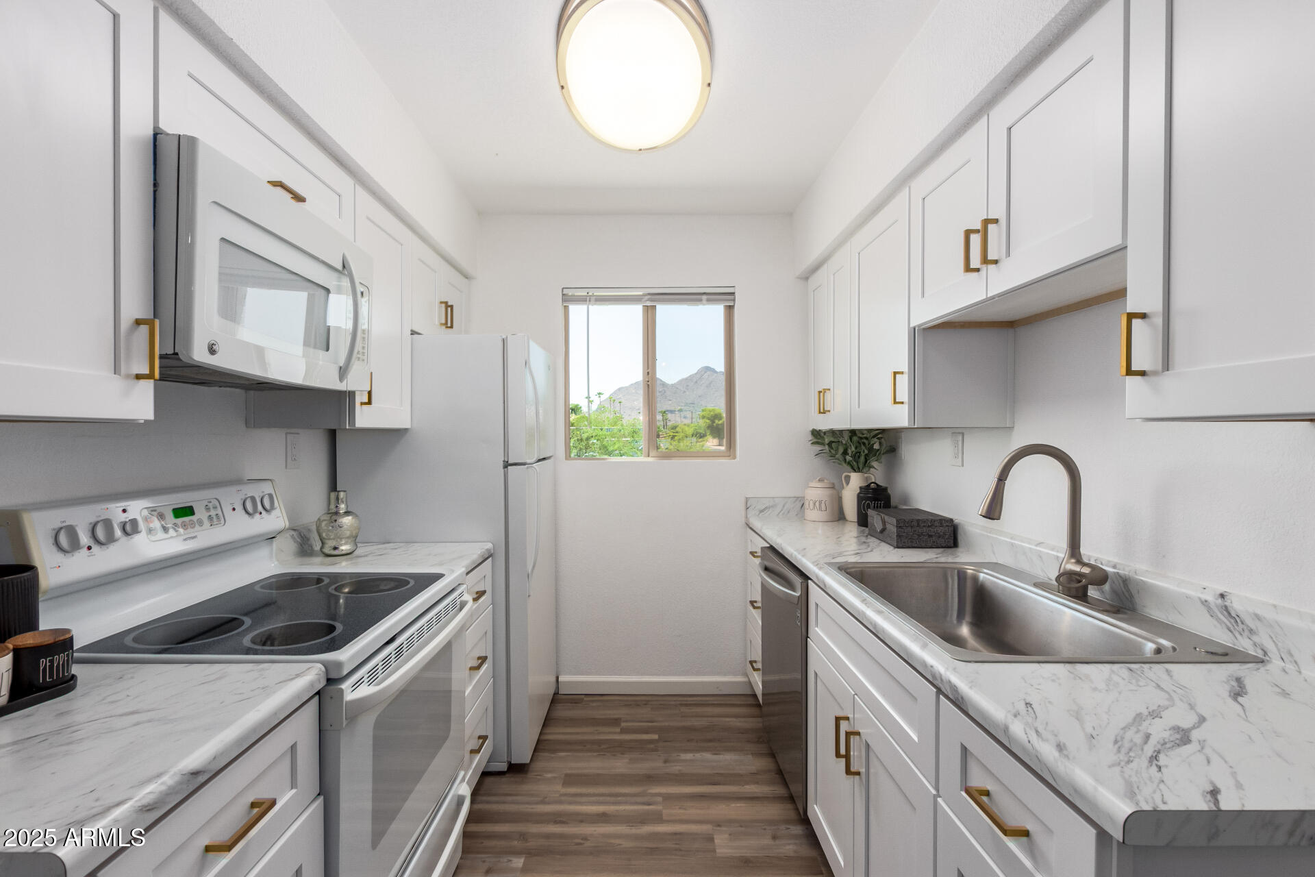 7430 East Chaparral Road, Unit 245A Scottsdale, AZ 85250 - Photo 9 of 30 a kitchen with stainless steel appliances granite countertop a sink stove and cabinets