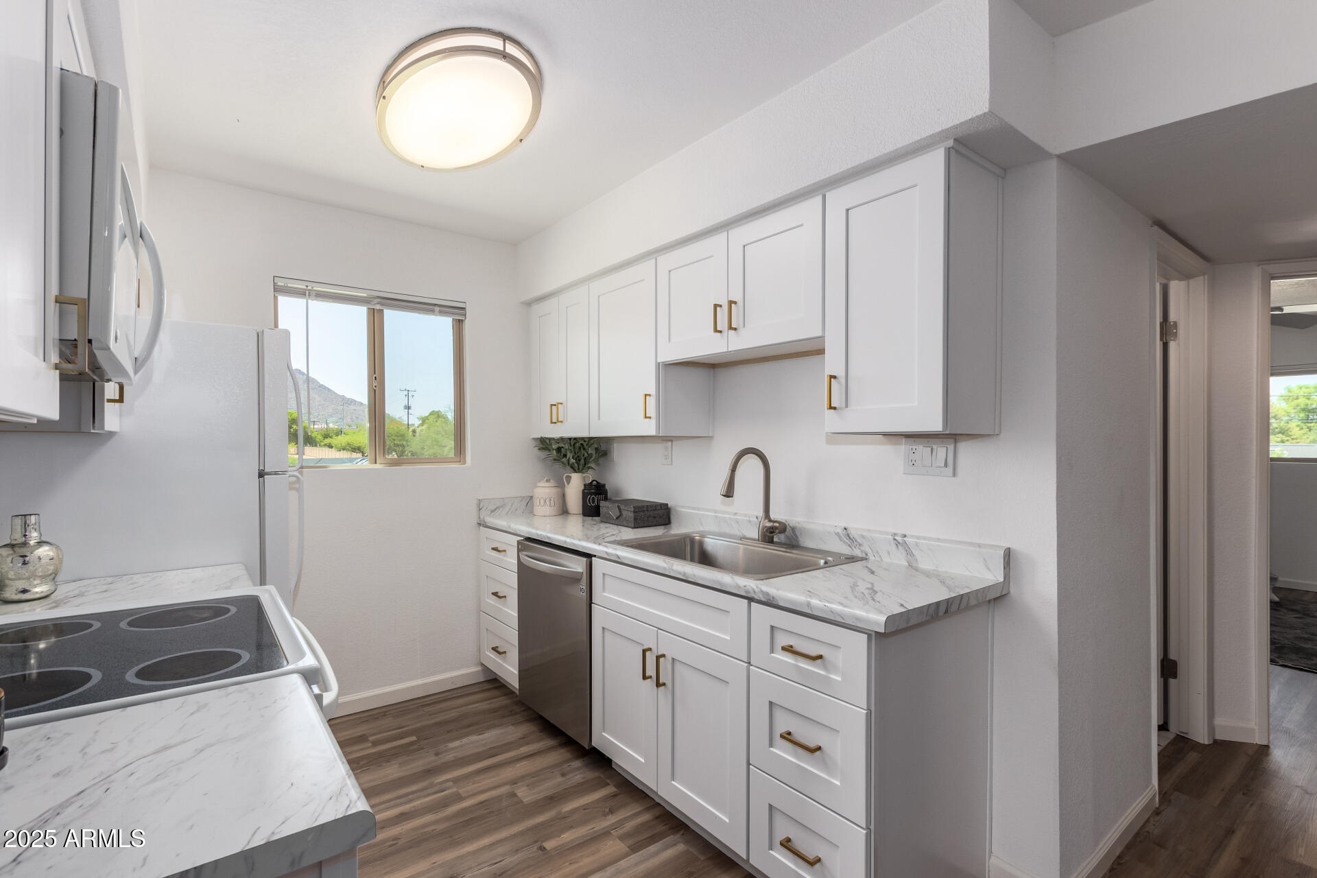 7430 East Chaparral Road, Unit 245A Scottsdale, AZ 85250 - Photo 10 of 30 a kitchen with cabinets appliances a sink and a window
