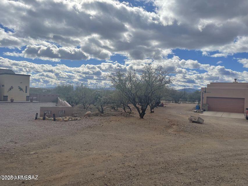 1732 Avenida Pastor, Unit 13 Rio Rico, AZ 85648 - Photo 3 of 5 a view of a dry yard with wooden fence