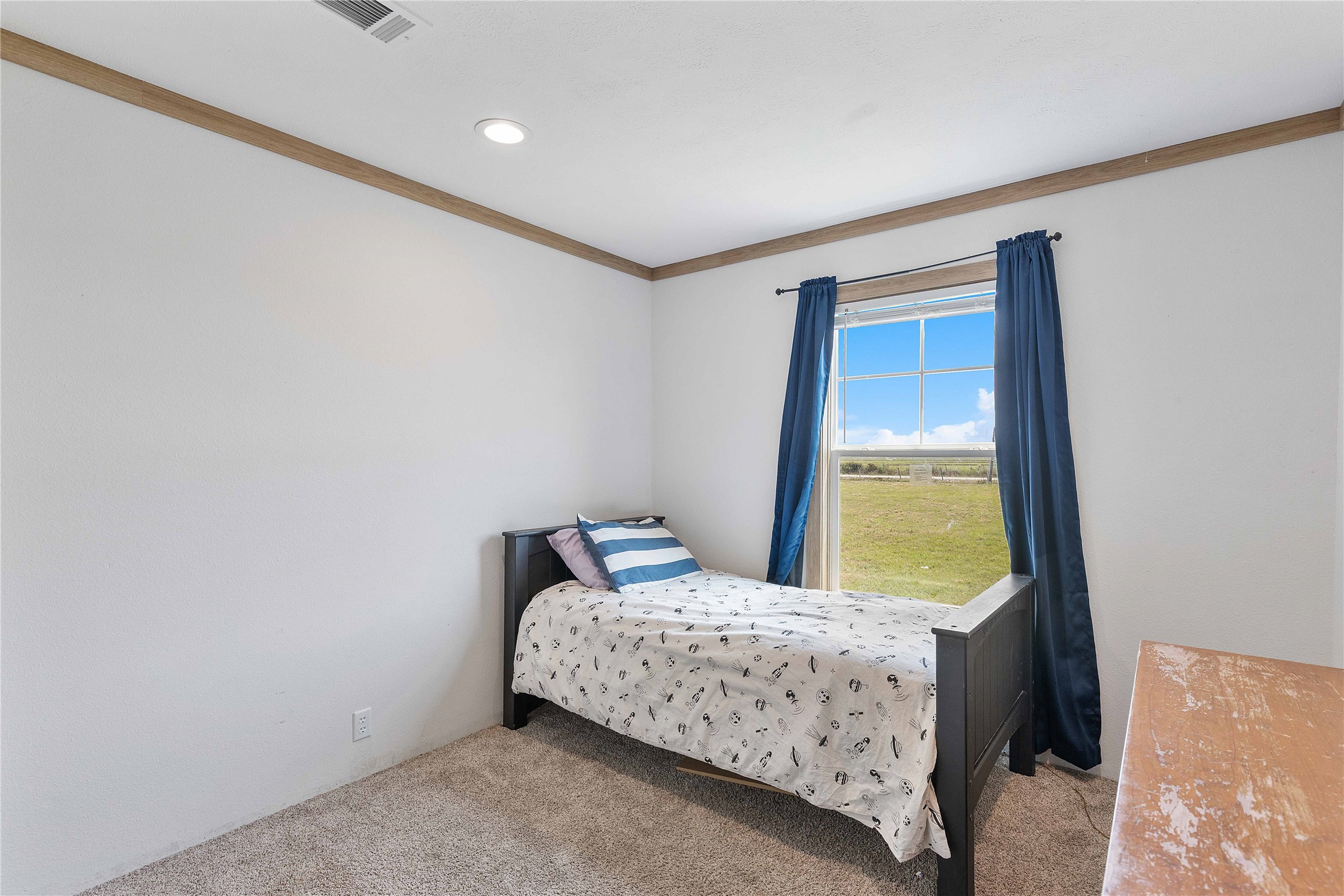 21550 Wilber Road Winnie, TX 77665 - Photo 24 of 28 a bedroom with a bed and a window