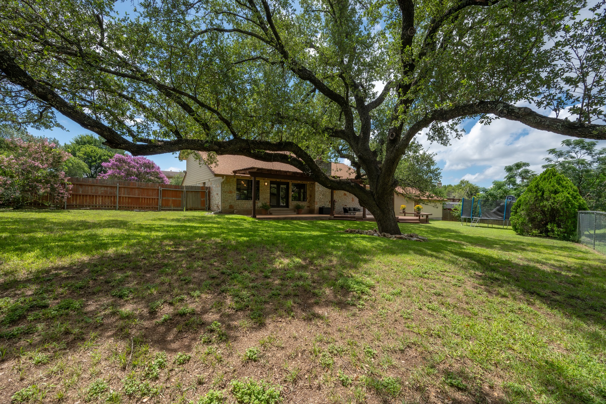 3908 Valley View Round Rock, TX 78681 - Photo 27 of 39 The backyard gives peaceful, serene vibes with mature trees and wide lawn space,