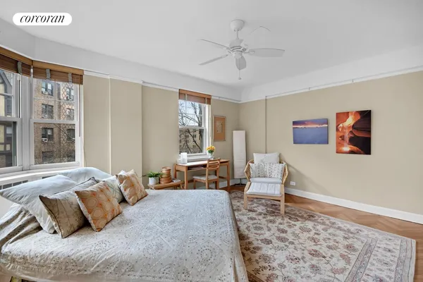 a bedroom with a bed couch and a window