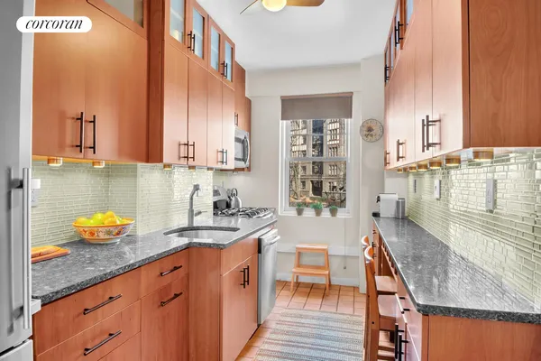 a kitchen with a sink a stove and cabinets