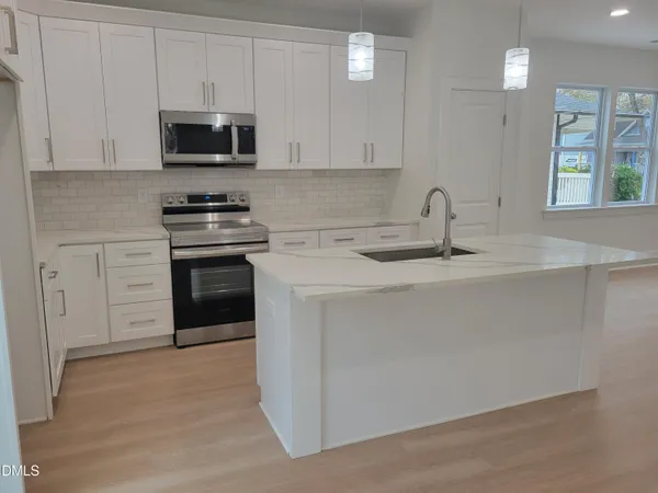 a view of a kitchen with electric appliances