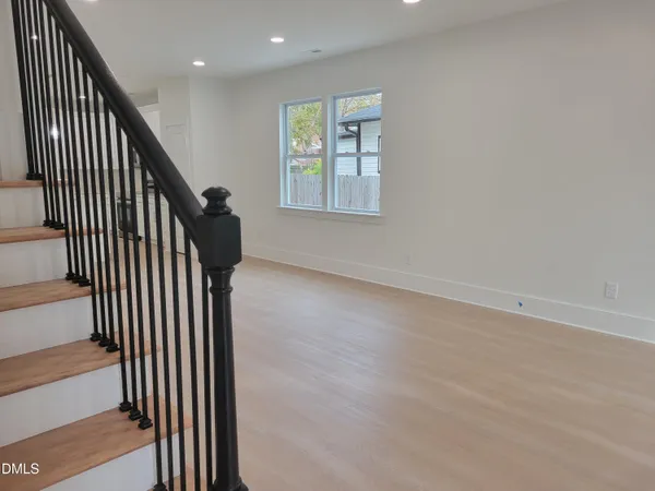 a kitchen with kitchen island a sink wooden floor and a large window