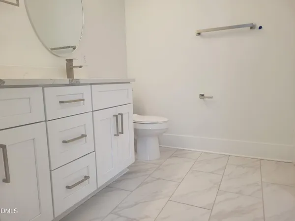 a bathroom with a sink toilet and vanity