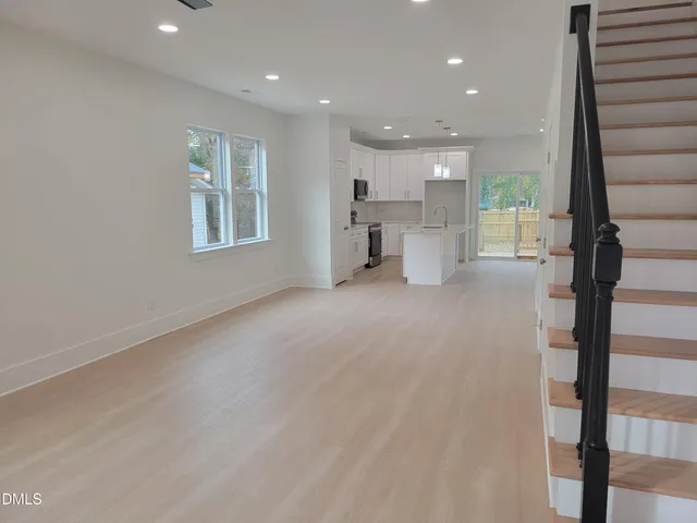 a kitchen with a sink a stove and cabinets